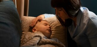 Important Info: What to Do if Your Child Has Hand, Foot, and Mouth Disease Mother with her sick child sleeping | Hand, Foot, Mouth Disease Concept Photo