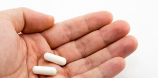Close up of magnesium Capsules in a man's hand