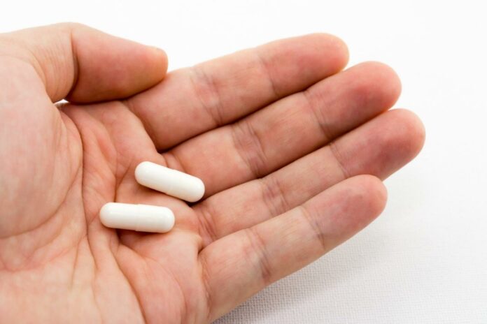 Close up of magnesium Capsules in a man's hand